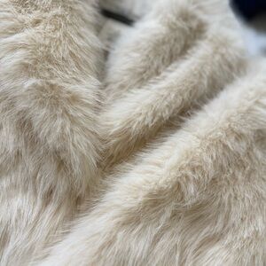 Off white/cream faux fur coat. New with tags, never worn.